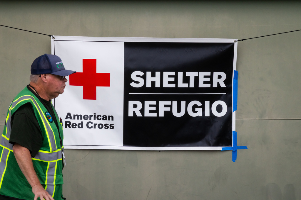 An American Red Cross volunteer walks outside Freedom Hall, an evacuation center in Fountain Valley, Calif.,on Monday, May 25, 2026. (AP Photo/Ethan Swope)