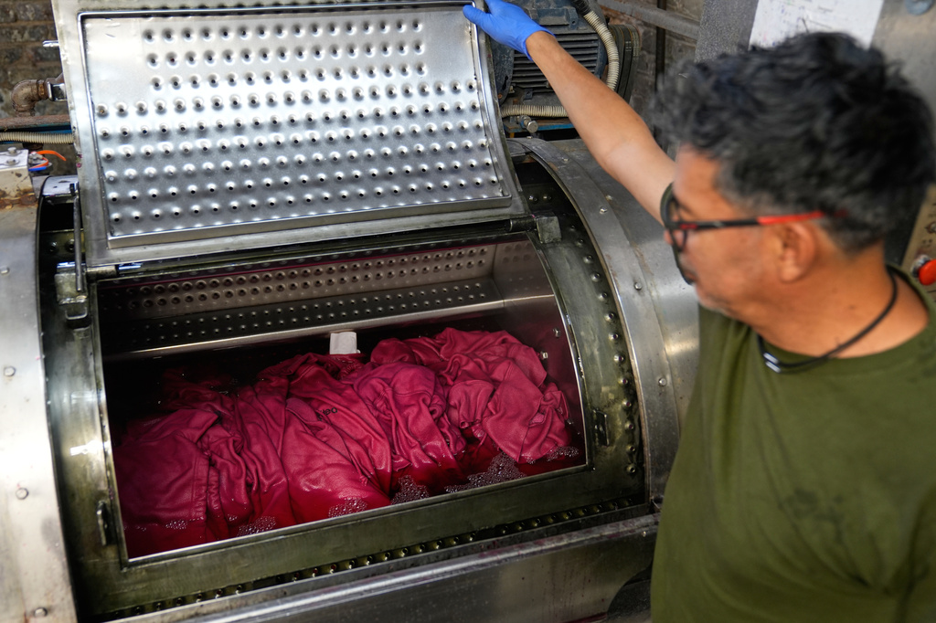 A small run of sweatshirts are dyed at the BPD Washhouse, a denim processing facility, in Jersey City, N.J., Tuesday, May 5, 2026. (AP Photo/Seth Wenig)