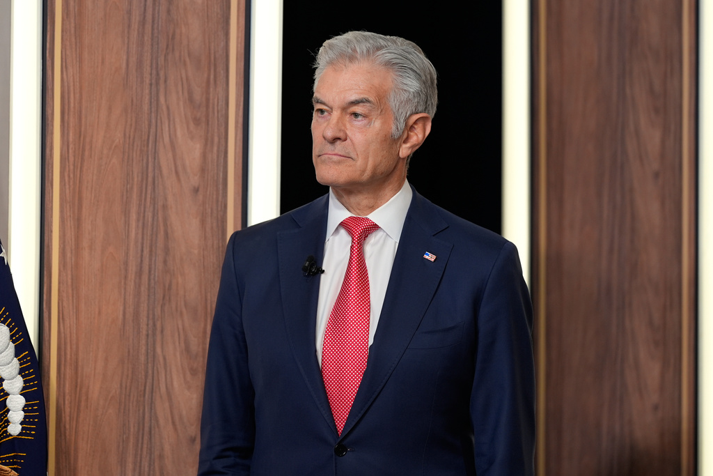 Centers for Medicare & Medicaid Services administrator Dr. Mehmet Oz listens as President Donald Trump speaks about TrumpRx in the South Court Auditorium in the Old Eisenhower Executive Office Building on the White House campus, Thursday, Feb. 5, 2026, in Washington. (AP Photo/Alex Brandon)