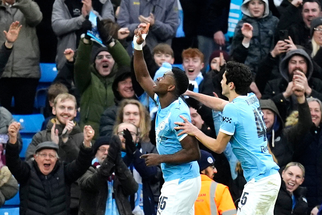 Manchester City's Marc Guehi, left, celebrates scoring during the English FA Cup fourth round soccer match between Manchester City and Salford City in Manchester, England, Saturday Feb. 14, 2026. (Nick Potts/PA via AP)