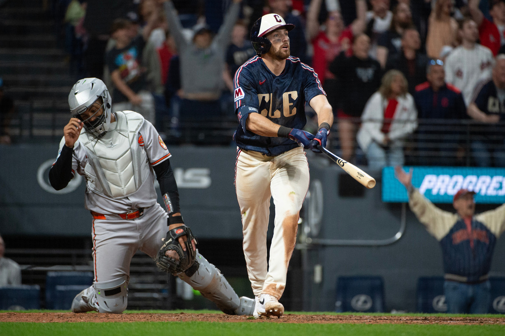 Cleveland Guardians' Daniel Schneemann watches his grand slam home run off Baltimore Orioles relief pitcher Anthony Nunez as catcher Samuel Basallo looks away during the seventh inning of a baseball game, Friday, April 17, 2026, in Cleveland. (AP Photo/Phil Long)