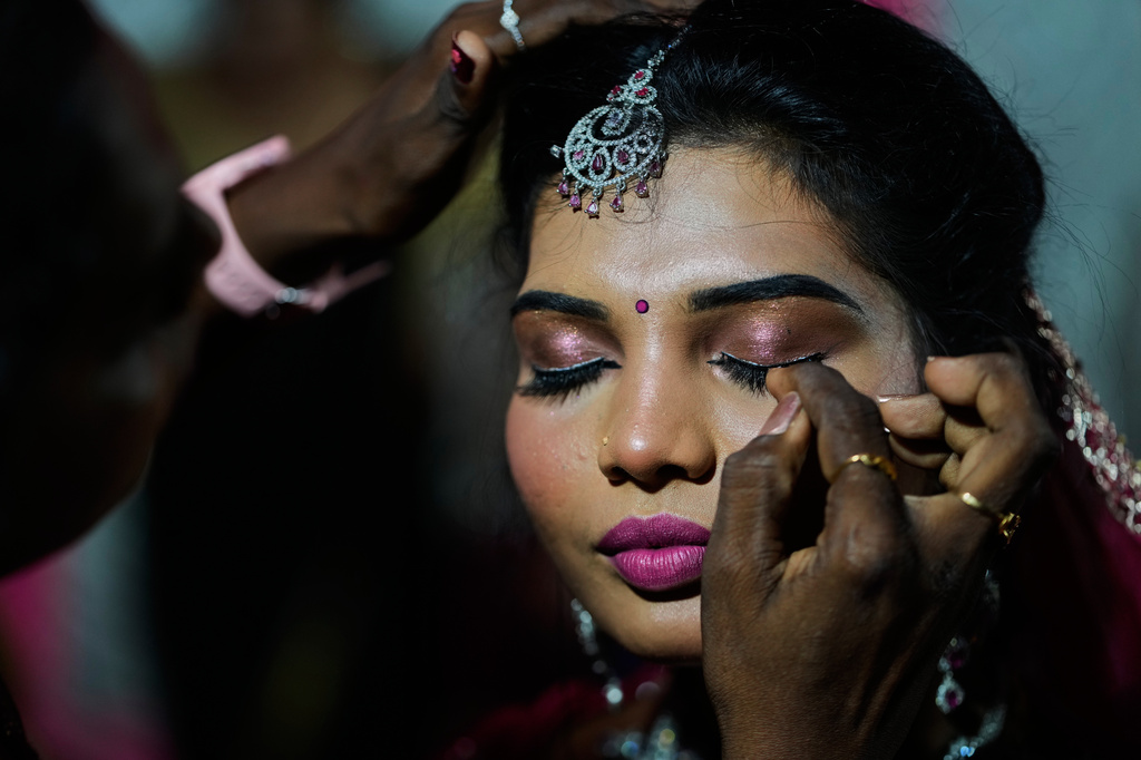 A transgender participant gets ready before taking part in Miss Koovagam 2026 beauty pageant during Koovagam festival in Villupuram, India, Monday, April 27, 2026. (AP Photo/Mahesh Kumar A.)