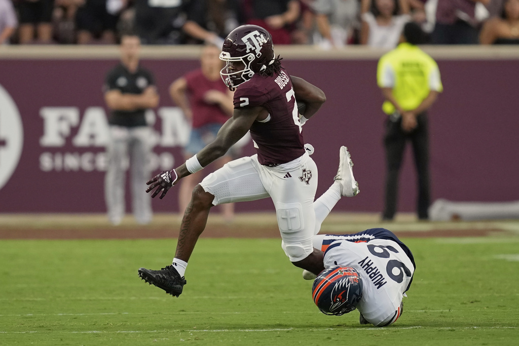 Texas A&M's Terry Bussey (2) is tackled by UTSA kicker Jaffer Murphy (99) during the first half of an NCAA college football game Saturday, Aug. 30, 2025, in College Station, Texas. (AP Photo/David J. Phillip)