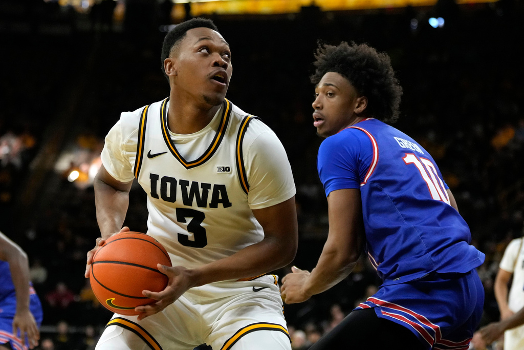 Iowa forward Cam Manyawu (3) drives to the basket past UMass-Lowell forward Austin Green (10) during the first half of an NCAA college basketball game, Monday, Dec. 29, 2025, in Iowa City, Iowa. (AP Photo/Charlie Neibergall)