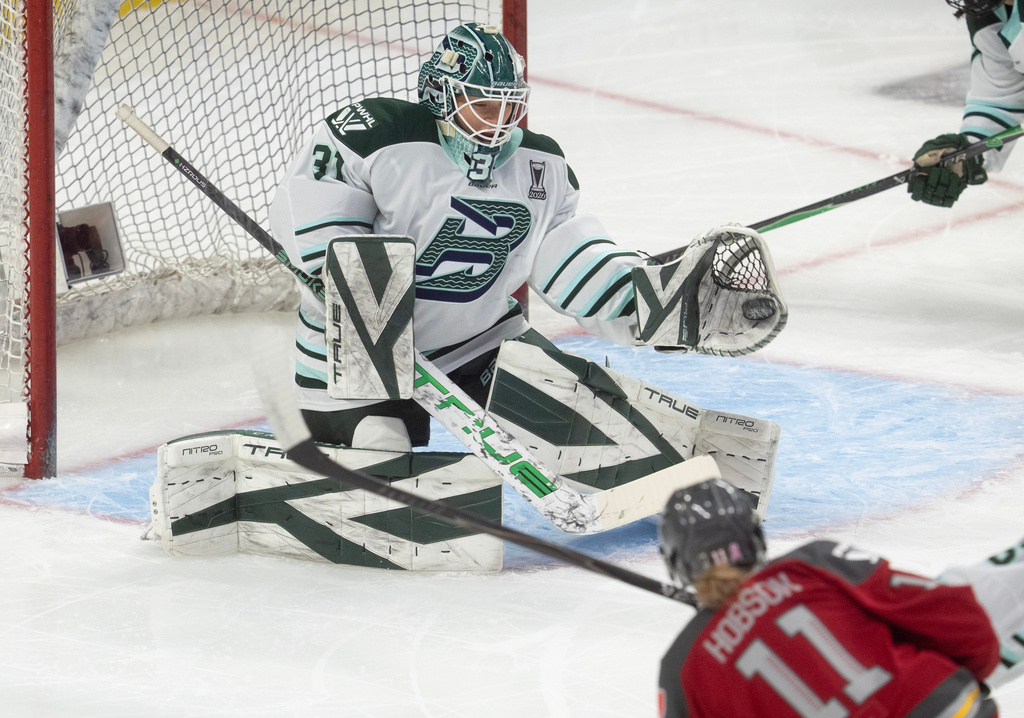 Boston Fleet goalie Aerin Frankel (31) makes a glove-save on a shot by Ottawa Charge's Brooke Hobson (11) during the first period of Game 4 in a PWHL hockey playoff series in Ottawa, Ontario, Sunday, May 10, 2026. (Adrian Wyld/The Canadian Press via AP)