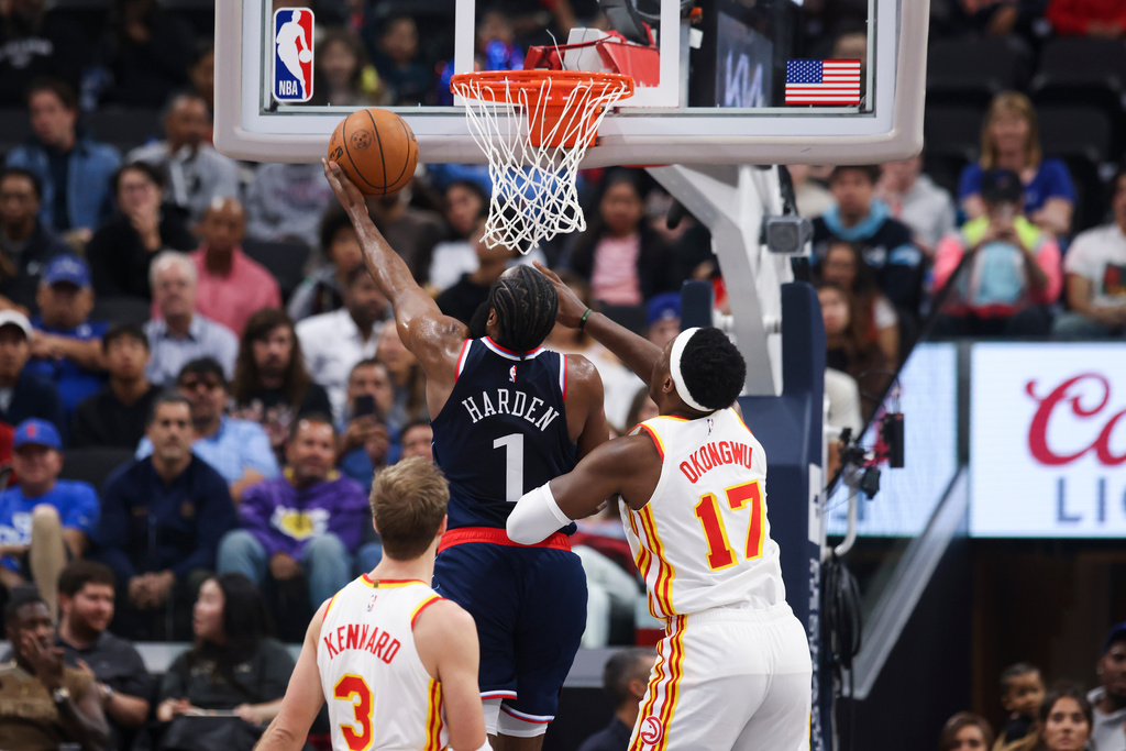 Los Angeles Clippers guard James Harden (1) drives to the basket against Atlanta Hawks forward Onyeka Okongwu (17) as guard Luke Kennard (3) watches during the first half of an NBA basketball game Monday, Nov. 10, 2025, in Inglewood, Calif. (AP Photo/Jessie Alcheh)