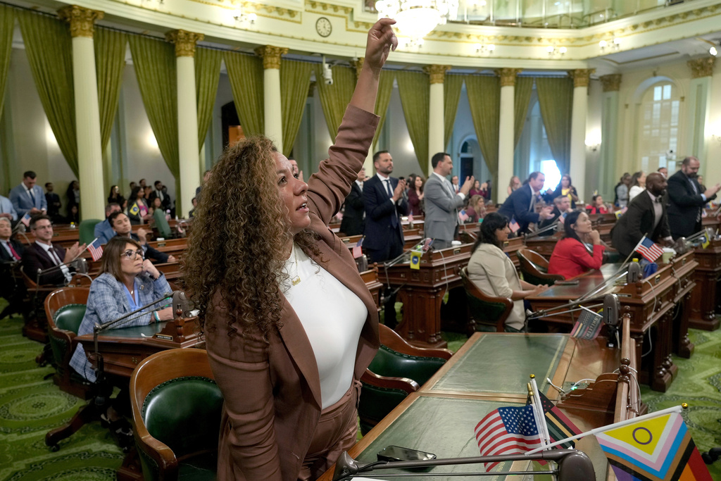 California Assembly member Sade Elhawary, D-Los Angeles, celebrates after the Assembly approved the first of three measures to redraw the state's Congressional districts and put new maps before voters in a special election, during a news conference in Sacramento, Calif., Thursday, Aug. 21, 2025. (AP Photo/Rich Pedroncelli)