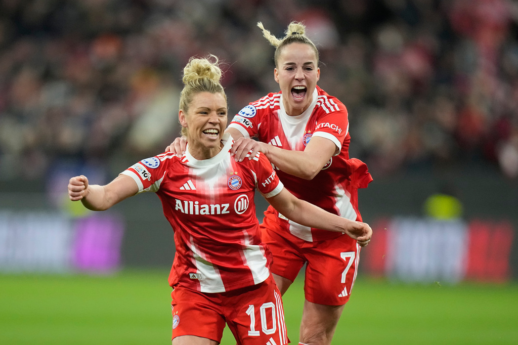 Bayern's Linda Dallmann, left, celebrates with Bayern's Giulia Gwinn after she scores her side's second goal during the Women's Champions League quarterfinal second leg soccer match between Bayern Munich and Manchester United in Munich, Germany, Wednesday, April 1, 2026. (AP Photo/Matthias Schrader)