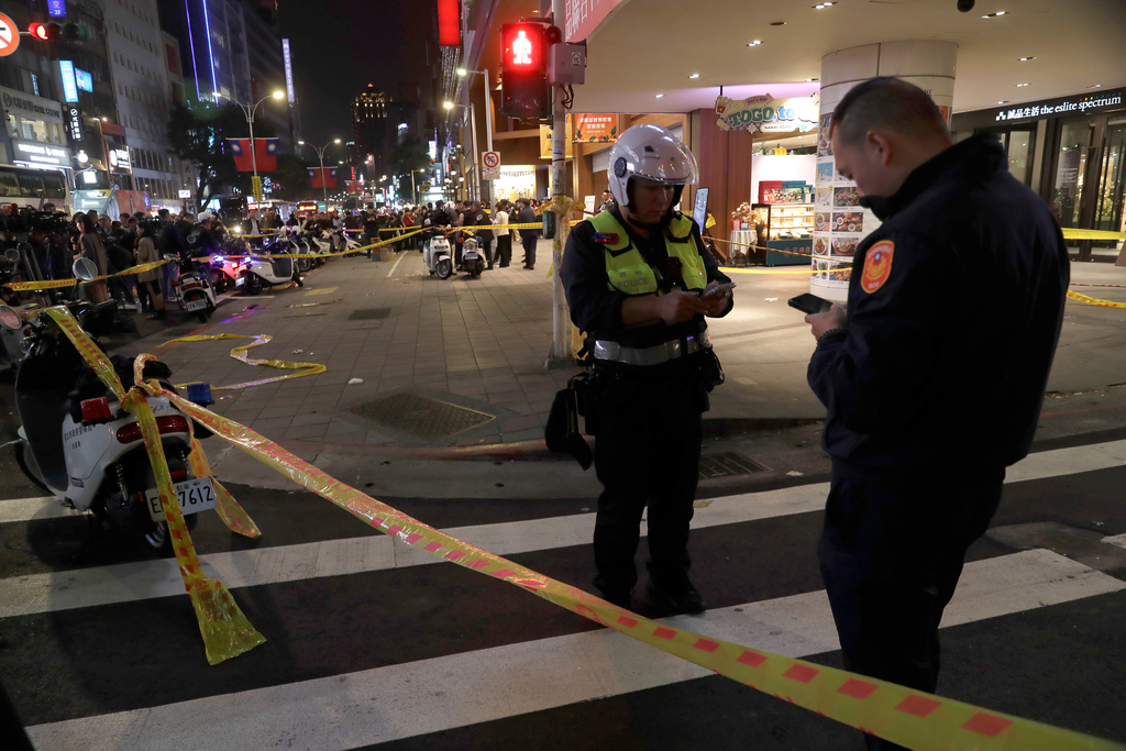 Taiwan police cordoned off the scene after a knife attack in Taipei, Taiwan, Friday, Dec. 19, 2025. (AP Photo/Chiang Ying-ying)