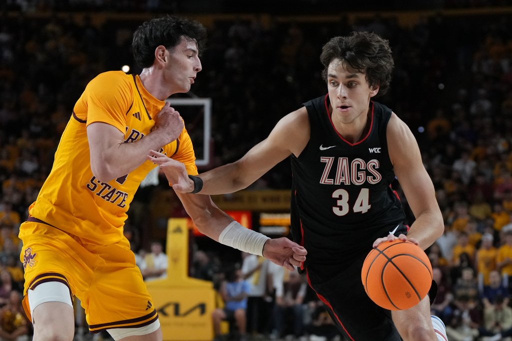 Gonzaga forward Braden Huff (34) drives against Arizona State forward Santiago Trouet during the first half of an NCAA college basketball game, Friday, Nov. 14, 2025, in Tempe, Ariz. (AP Photo/Rick Scuteri)