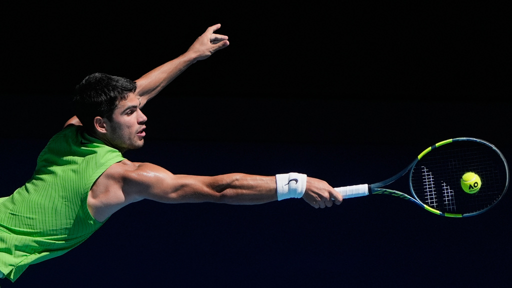 Carlos Alcaraz of Spain plays a backhand return to Corentin Moutet of France during their third round match at the Australian Open tennis championship in Melbourne, Australia, Friday, Jan. 23, 2026. (AP Photo/Asanka Brendon Ratnayake)