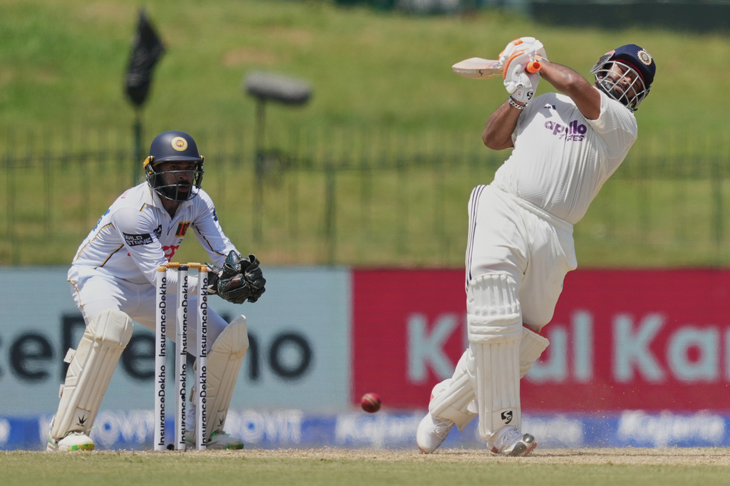 India's Rishabh Pant plays a shot as Sri Lanka's Niroshan Dickwella watches during day two of the second cricket test match between Sri Lanka and India in Colombo, Sri Lanka, Monday, Aug. 24, 2026. (AP Photo/Eranga Jayawardena)