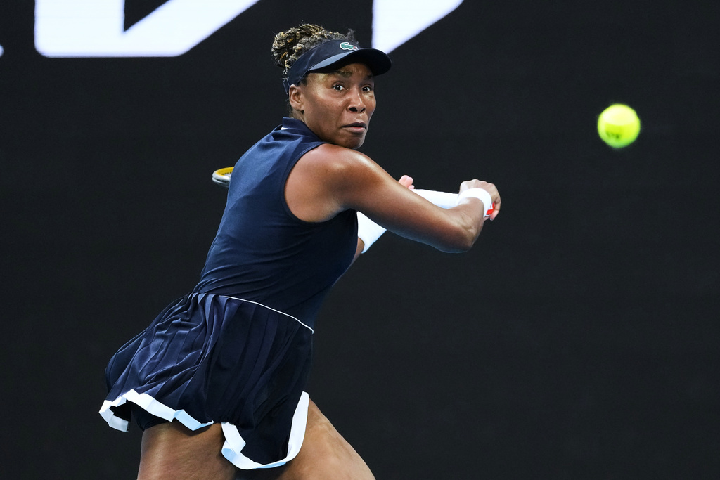 Venus Williams of the U.S. plays a backhand return to Olga Danilovic of Serbia during their first round match at the Australian Open tennis championship in Melbourne, Australia, Sunday, Jan. 18, 2026. (AP Photo/Aaron Favila)