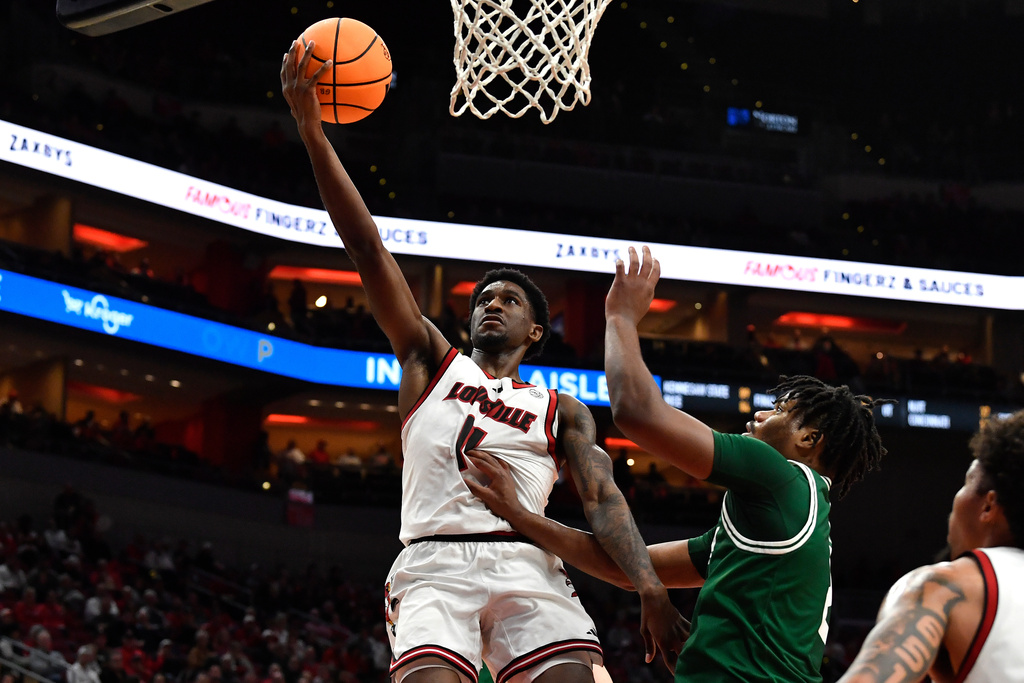 Louisville guard Kobe Rodgers (11) goes in for a layup past Eastern Michigan guard Carlos Hart (2) during the second half of an NCAA college basketball game in Louisville, Ky., Monday, Nov. 24, 2025. (AP Photo/Timothy D. Easley)