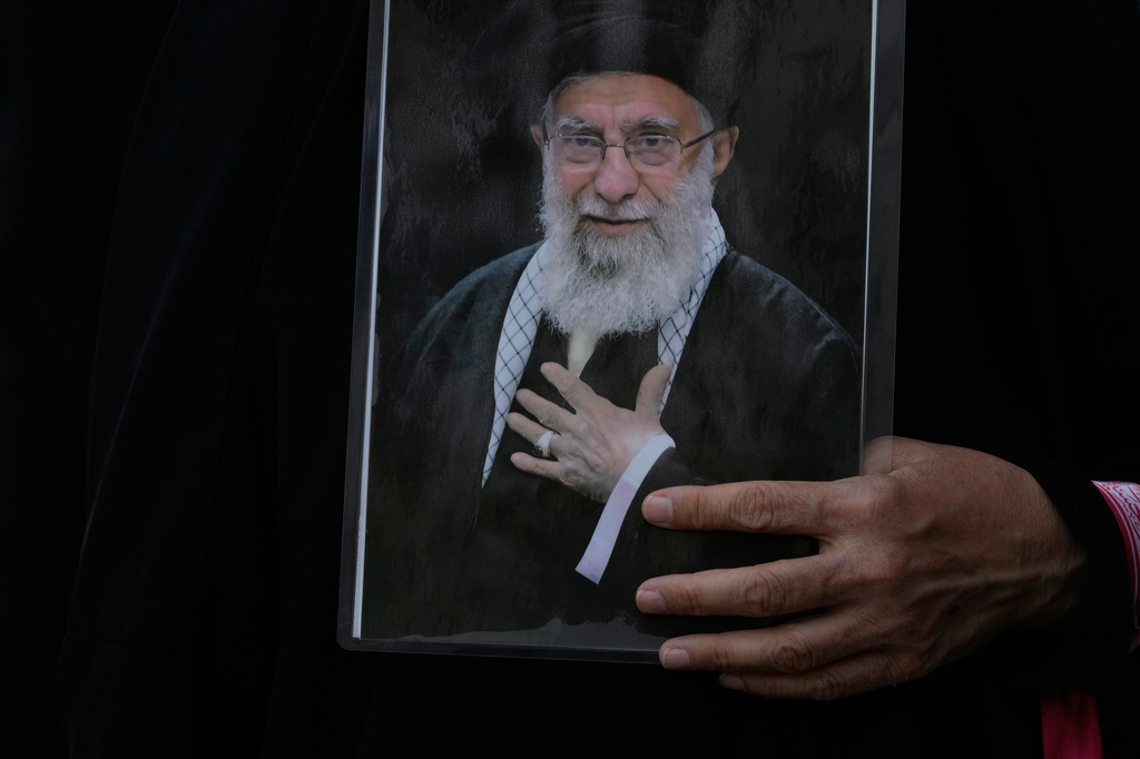 A woman holds a poster of the late Iranian Supreme Leader Ayatollah Ali Khamenei during his funeral procession in Tehran, Iran, Monday, July 6, 2026. (AP Photo/Vahid Salemi)