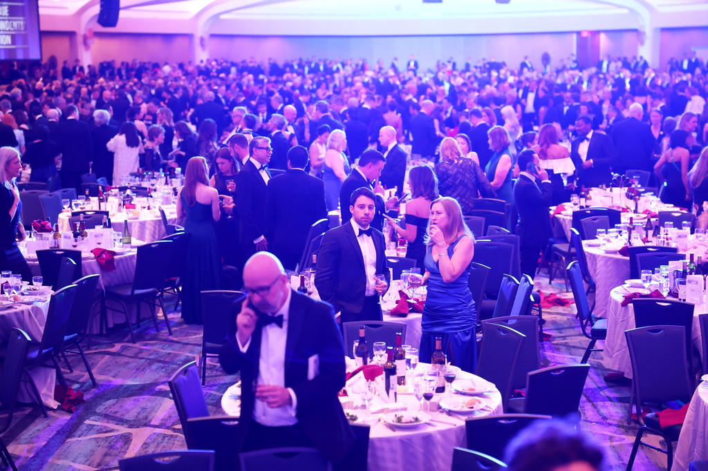 Guests begin to exit during the White House Correspondents Dinner, Saturday, April 25, 2026, in Washington. (AP Photo/Tom Brenner)