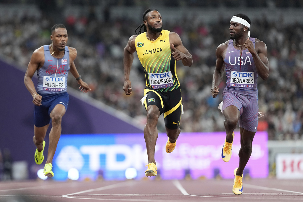 United States' Kenneth Bednarek, Jamaica's Kishane Thompson and Britain's Zharnel Hughes race in a men's 100 meters semifinal at the World Athletics Championships in Tokyo, Sunday, Sept. 14, 2025. (AP Photo/Petr David Josek)