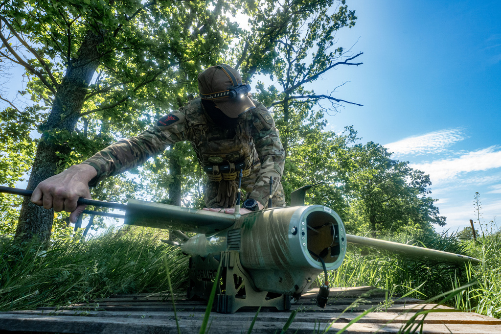 A Ukrainian serviceman of Khartia brigade launches a drone towards Russian positions at the front line in the Kharkiv region, Ukraine, Wednesday, May 20, 2026. (AP Photo/Andrii Marienko)