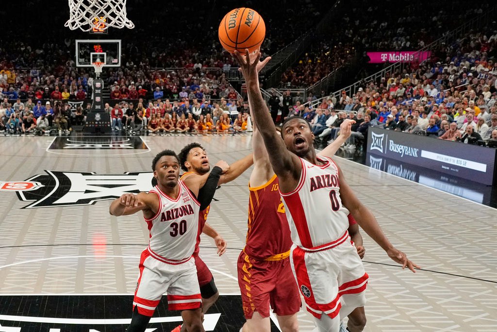 Arizona guard Jaden Bradley (0) puts up a shot during the second half of an NCAA college basketball game against Iowa State in the semifinal round of the Big 12 Conference tournament Friday, March 13, 2026, in Kansas City, Mo. (AP Photo/Charlie Riedel)