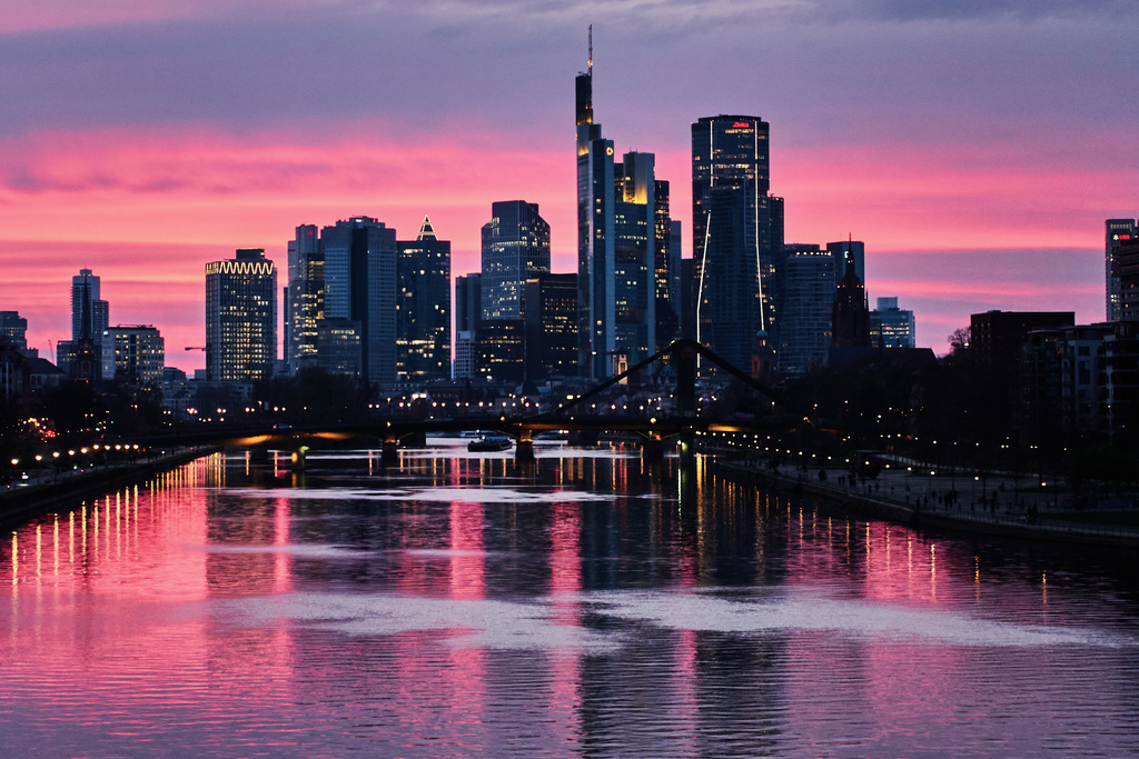 The sun has set behind the buildings of the banking district in Frankfurt, Germany, late Tuesday, March 24, 2026. (AP Photo/Michael Probst)
