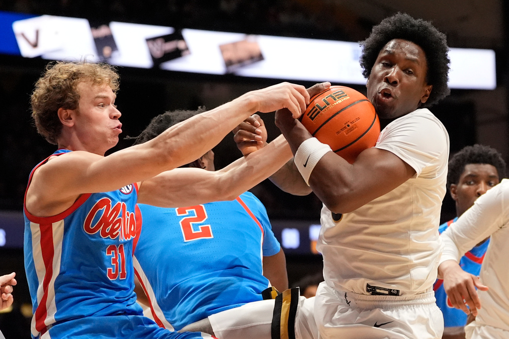 Vanderbilt guard Mike James, right, battles Mississippi guard Zach Day (31) for a rebound during the first half of an NCAA college basketball game Saturday, Jan. 31, 2026, in Nashville, Tenn. (AP Photo/George Walker IV)