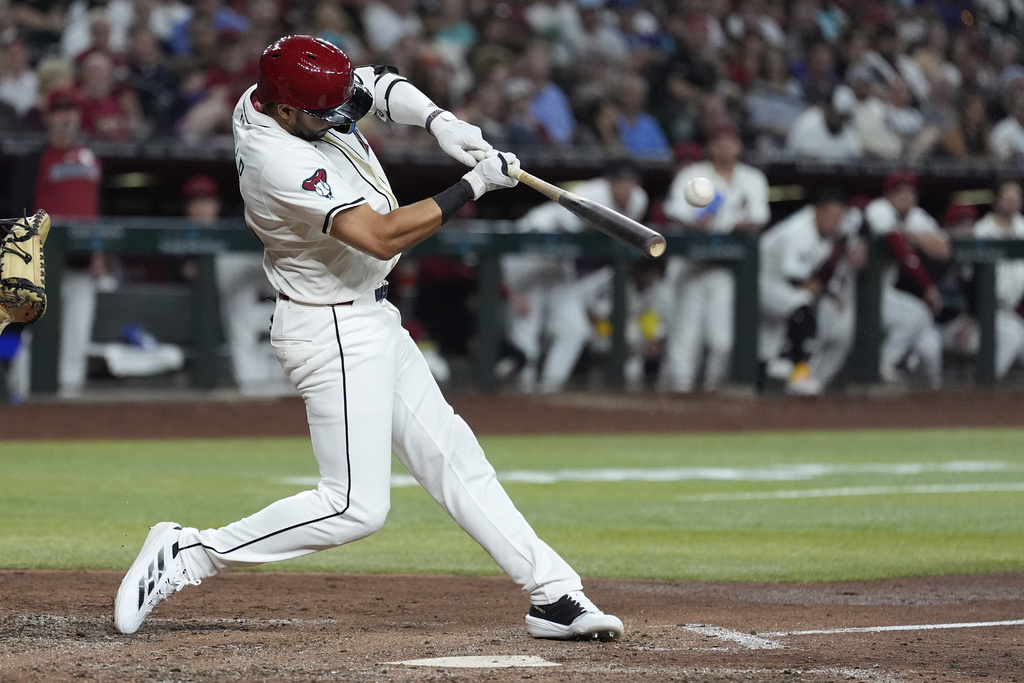 Arizona Diamondbacks' Jordan Lawlar connects for a run-scoring double against the San Francisco Giants during the sixth inning of a baseball game Monday, Sept. 15, 2025, in Phoenix. (AP Photo/Ross D. Franklin)