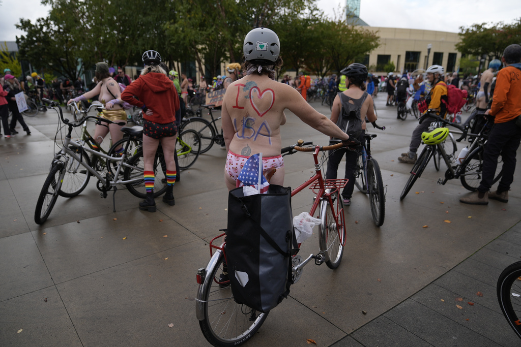 Participants prepare for the Naked Bike Ride protest on Sunday, Oct. 12, 2025, in Portland, Ore. (AP Photo/Jenny Kane)