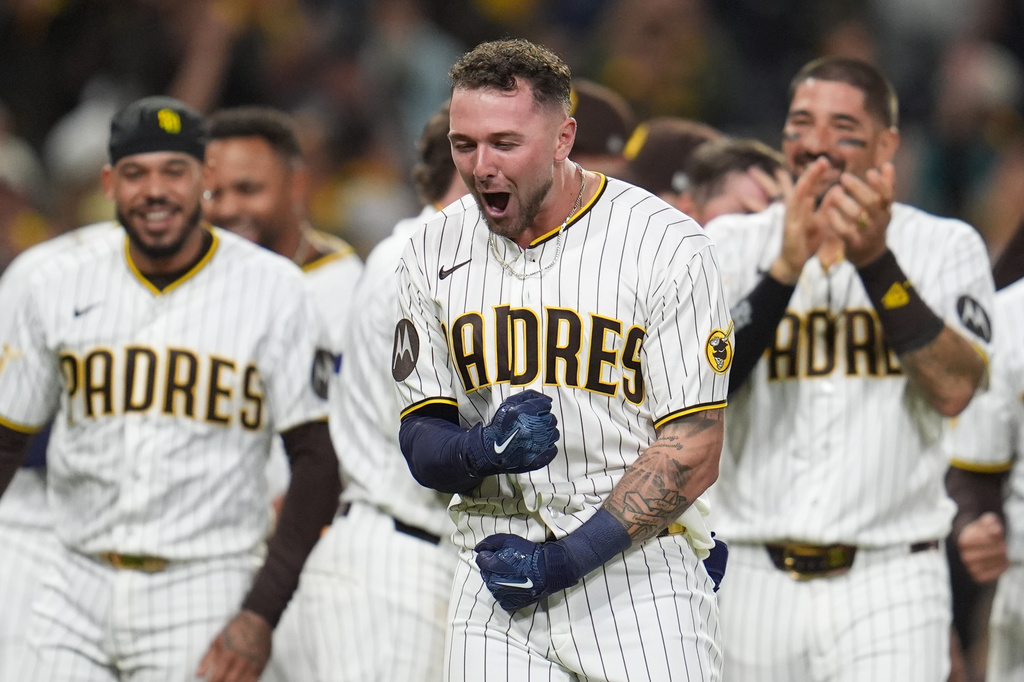 San Diego Padres' Jackson Merrill, center, celebrates with teammates after hitting a walk off double during the ninth inning of a baseball game against the Seattle Mariners Wednesday, April 15, 2026, in San Diego. (AP Photo/Gregory Bull)