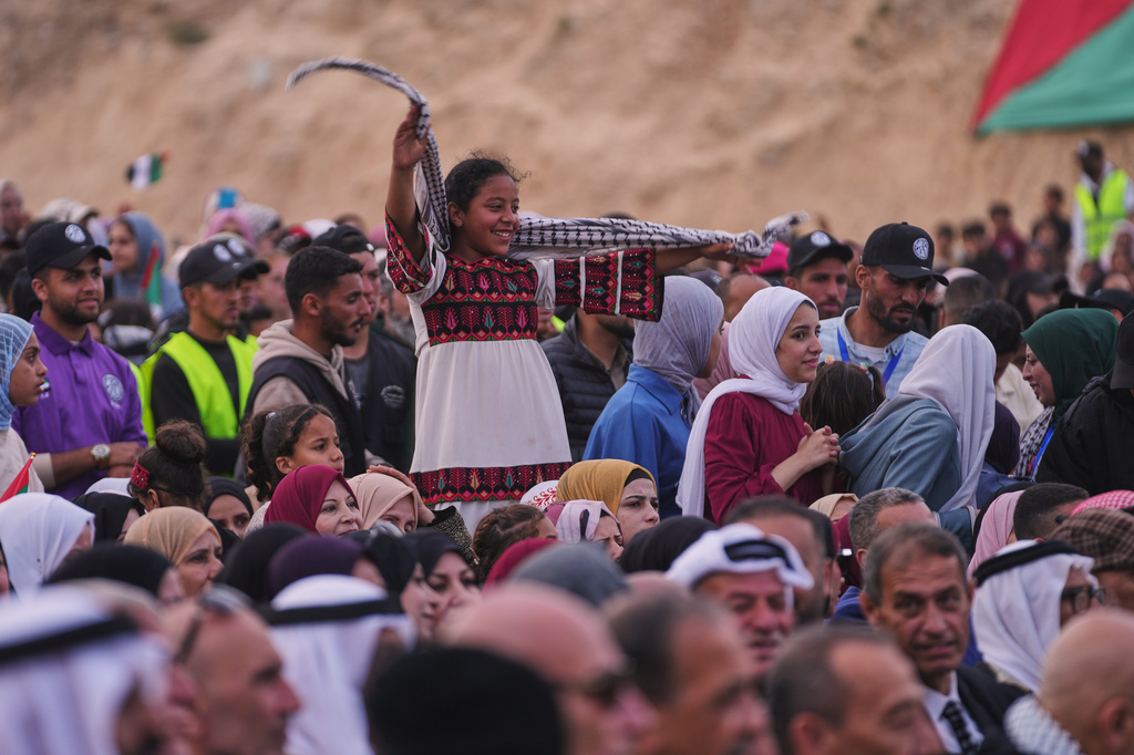 Palestinians watch and celebrate a mass wedding ceremony in Deir al-Balah, central Gaza Strip, Friday, April 24, 2026. (AP Photo/Abdel Kareem Hana)