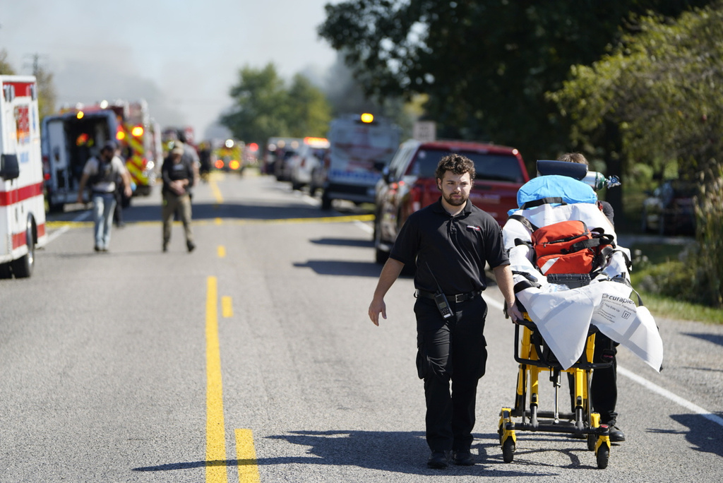 Emergency responders work the scene outside The Church of Jesus Christ of Latter-day Saints following a shooting and fire in Grand Blanc, Mich., Sunday, Sept. 28, 2025. (Lukas Katilius/The Flint Journal via AP)
