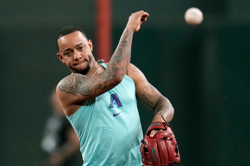 Returning Arizona Diamondbacks' Ketel Marte throws during infield practice prior to a baseball game against the Philadelphia Phillies, Monday, Aug. 31, 2026, in Phoenix. (AP Photo/Ross D. Franklin)