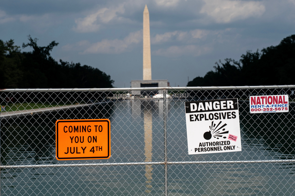 Signage and security fencing warns of explosives along the Lincoln Memorial Reflecting Pool ahead of July 4th events on the National Mall, Wednesday, July 1, 2026, in Washington. (AP Photo/Nathan Howard)