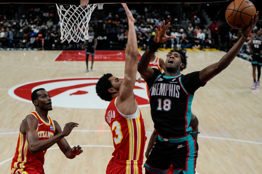 Memphis Grizzlies forward Olivier-Maxence Prosper (18) shoots against against the Atlanta Hawks during the second half of an NBA basketball game, Monday, March 23, 2026, in Atlanta. (AP Photo/Mike Stewart)
