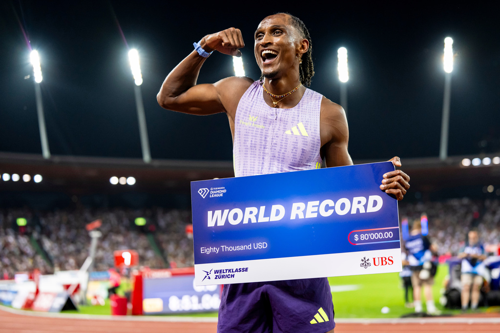 Brazil's Alison dos Santos celebrates winning the men's 400-meter hurdles, setting a new world record, at the Diamond League athletics meeting, Thursday, Aug. 27, 2026, in Zurich, Switzerland. (Jean-Christophe Bott/Keystone via AP)