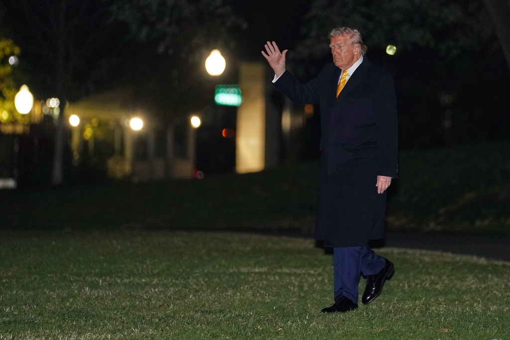President Donald Trump waves as he walks to board Marine One, Friday, Nov. 14, 2025, on the South Lawn of the White House, in Washington for a trip to Palm Beach, Fla. (AP Photo/Allison Robbert)
