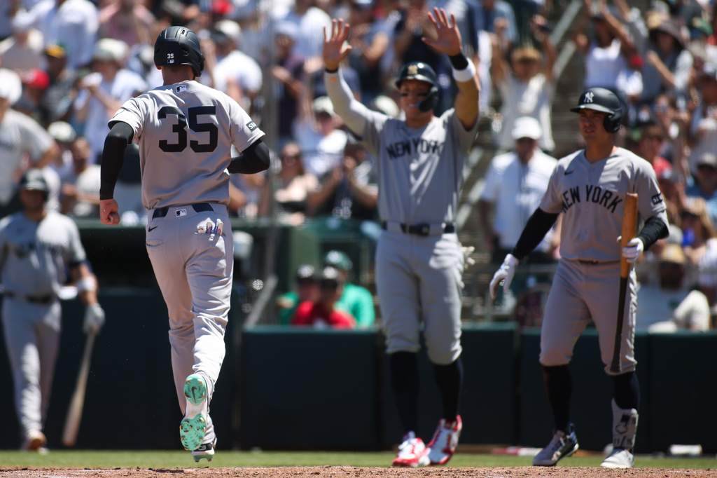 New York Yankees' Cody Bellinger (35) heads toward teammates after scoring during the third inning of a baseball game against the Athletics, Sunday, May 31, 2026, in West Sacramento, Calif. (AP Photo/Scott Marshall)