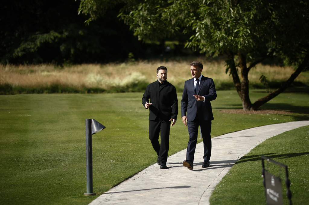 French President Emmanuel Macron, right, walks with Ukrainian President Volodymyr Zelenskyy at the Hotel Royal for the G7 Summit in Evian-les-Bains, France, Tuesday, June 16, 2026. (Yoan Valat/Pool Photo via AP)