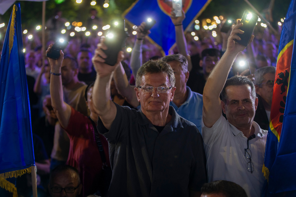 Supporters wave their lights at the closing political rally of the Democratic League of Kosovo (LDK), in capital Pristina on Friday, June 5, 2026. (AP Photo/Visar Kryeziu)