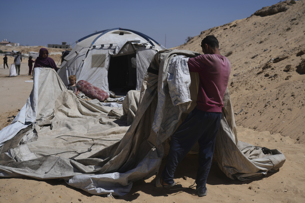 Members of the Abdullah family who were evacuated from Gaza City set up their tent in a camp for displaced Palestinians in Muwasi, an area that Israel has designated as a safe zone, in Khan Younis southern Gaza Strip, Wednesday, Sept. 10, 2025. (AP Photo/Jehad Alshrafi)