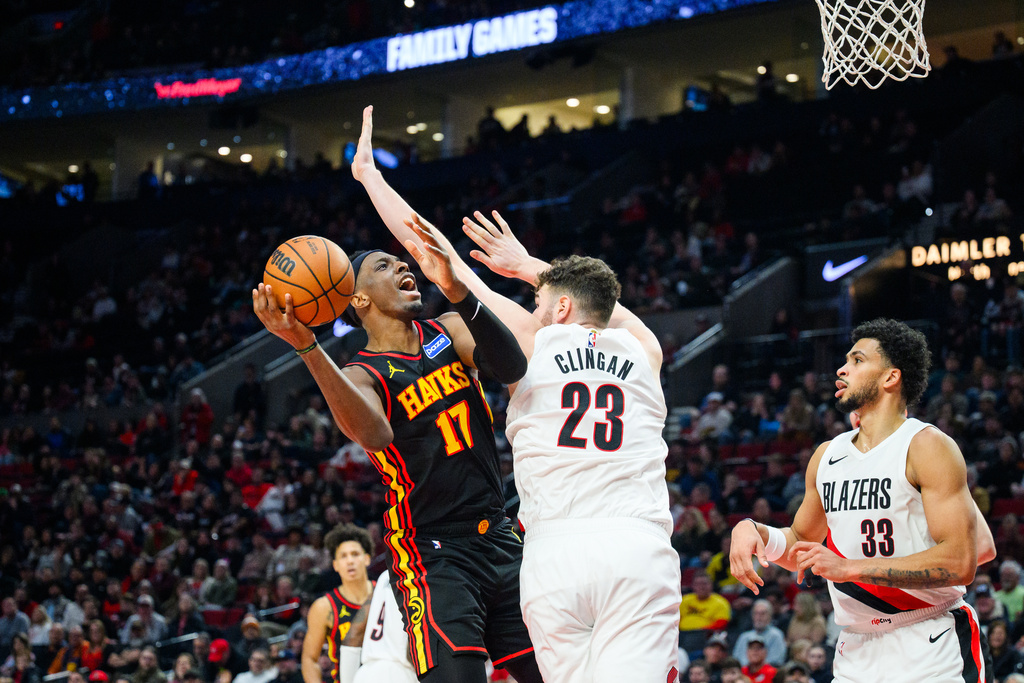 Portland Trail Blazers center Donovan Clingan (23) blocks a basket from Atlanta Hawks forward/center Onyeka Okongwu (17) during the first half of an NBA basketball game on Thursday, Jan. 15, 2026, in Portland, Ore. (AP Photo/Molly J. Smith)