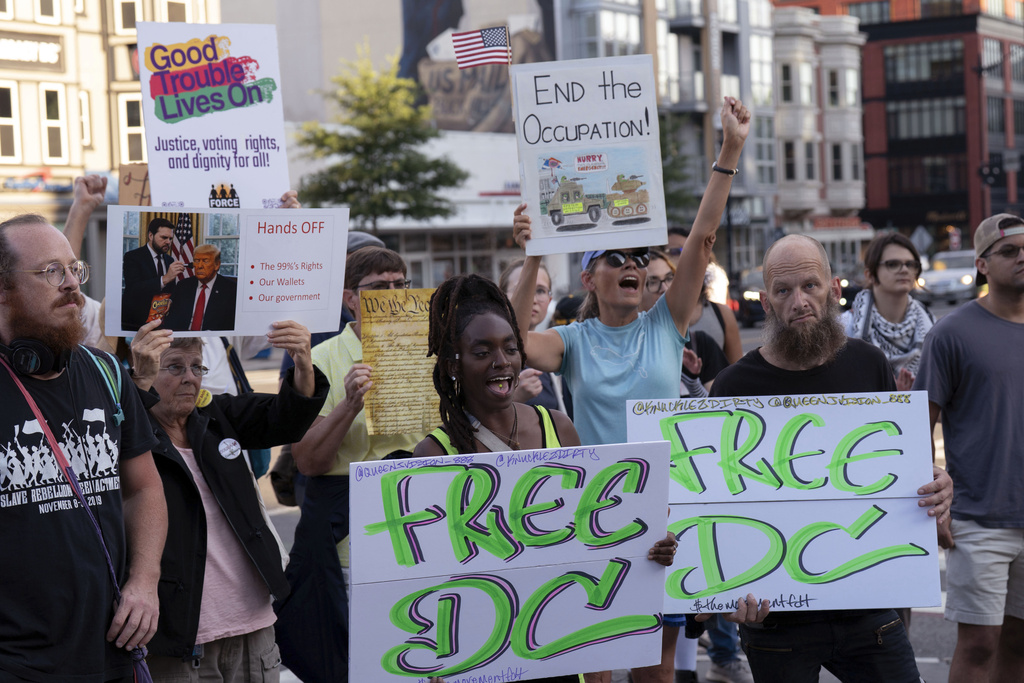 People protest against President Donald Trump's use of federal law enforcement and National Guard troops in the city during a rally along the U street corridor in northwest Washington, Saturday, Aug. 23, 2025. (AP Photo/Jose Luis Magana)