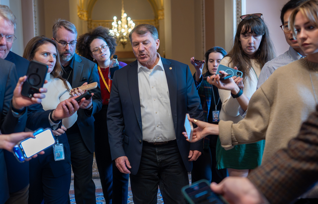 Sen. Mike Rounds, R-S.D., a member of the Senate Appropriations Committee, is surrounded by congressional reporters looking for updates on a plan to end the 38 day government shutdown, at the Capitol in Washington, Friday, Nov. 7, 2025. (AP Photo/J. Scott Applewhite)