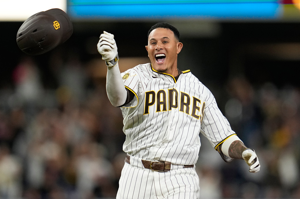 San Diego Padres' Manny Machado celebrates with teammates after hitting a walk off single to defeat the Atlanta Braves during the tenth inning of a baseball game Tuesday, June 23, 2026, in San Diego. (AP Photo/Gregory Bull)