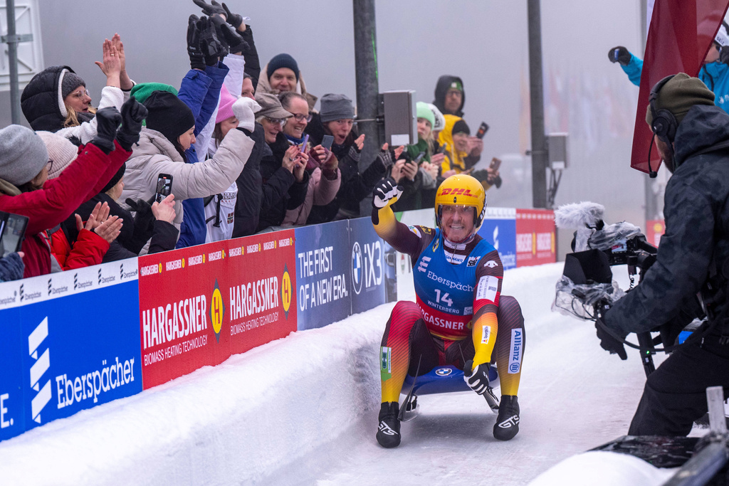 Felix Loch of Germany celebrates after the finish during the men's singles second run at the Luge World Championships in Winterberg, Germany, Saturday, Dec. 6, 2025. (David Inderlied/dpa via AP)