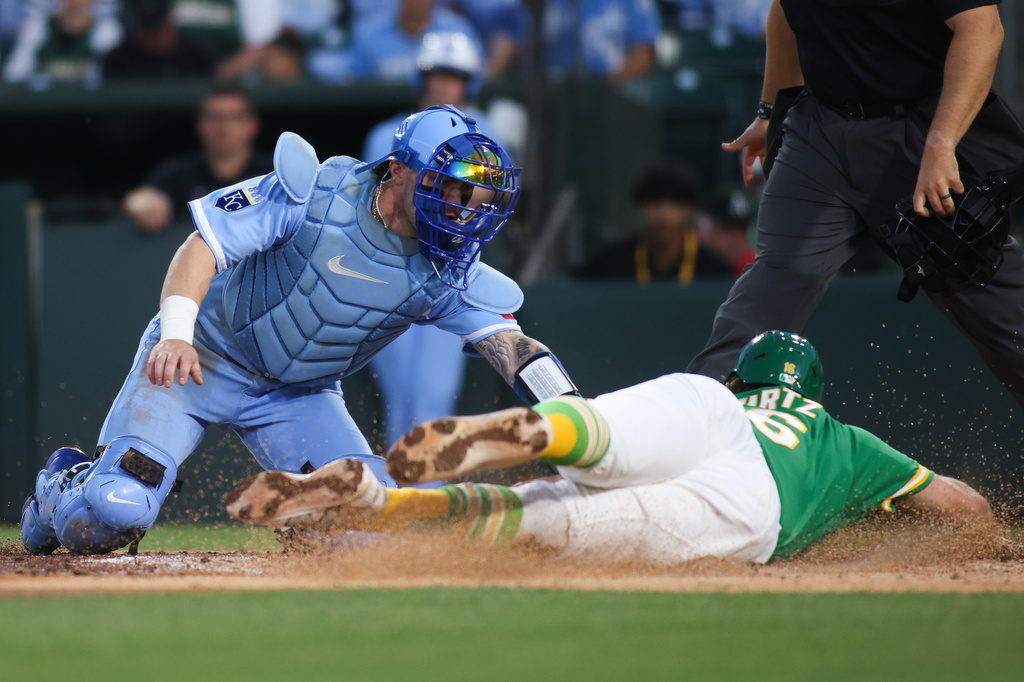 Kansas City Royals catcher Carter Jensen, left, attempts to tags out Athletics' Nick Kurtz, right, at home plate for the final out of the fourth inning of a baseball game Wednesday, April 29, 2026, in West Sacramento, Calif. (AP Photo/Scott Marshall)