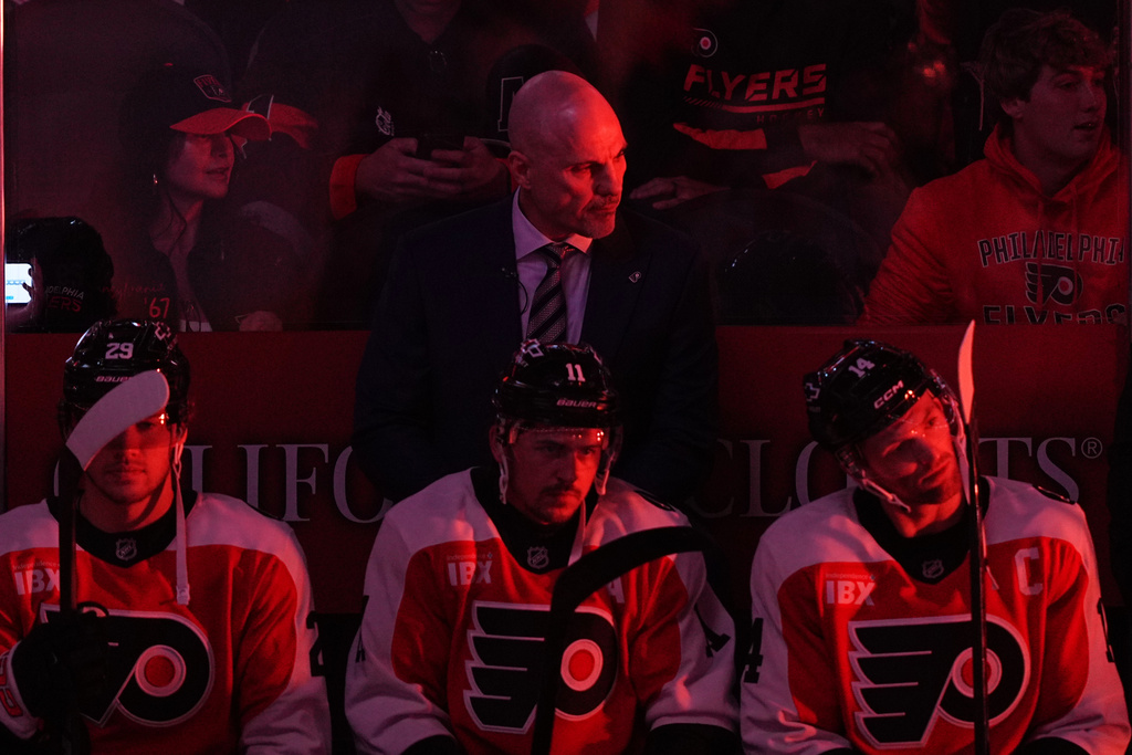 Philadelphia Flyers head coach Rick Tocchet, center top, looks on before an NHL hockey game against the Florida Panthers, Monday, Oct. 13, 2025, in Philadelphia. (AP Photo/Matt Rourke)