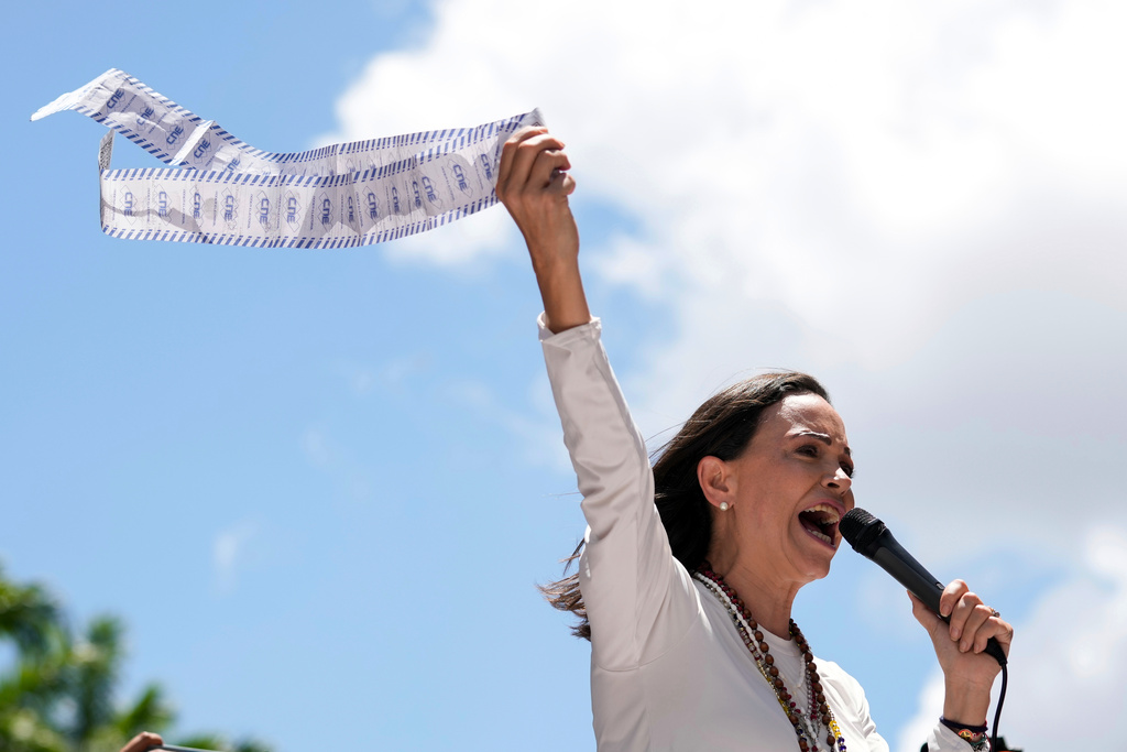 FILE - Opposition leader Maria Corina Machado displays vote tally sheets during a protest against the reelection of President Nicolas Maduro one month after the disputed presidential vote which she says the opposition won by a landslide, in Caracas, Venezuela, Wednesday, Aug. 28, 2024. (AP Photo/Ariana Cubillos, file)