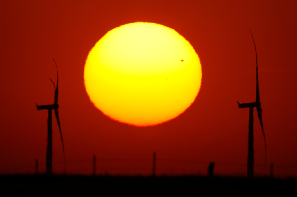 FILE - Wind turbines are silhouetted against the sky at sunset May 15, 2026, near Cimarron, Kan. (AP Photo/Charlie Riedel, File)