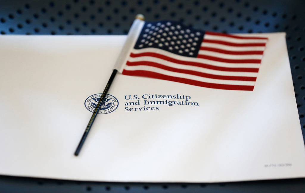 FILE - An information packet and an American flag are placed on a chair at the U.S. Citizenship and Immigration Services Miami Field Office on Aug. 17, 2018, in Miami. (AP Photo/Wilfredo Lee, File)