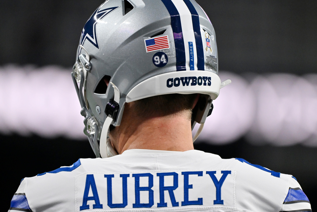 Dallas Cowboys place kicker Brandon Aubrey wears Cowboys' Marshawn Kneeland #94 on his helmet prior to an NFL football game against the Las Vegas Raiders Monday, Nov. 17, 2025, in Las Vegas, in memory of Kneeland who passed away earlier this month. (AP Photo/David Becker)